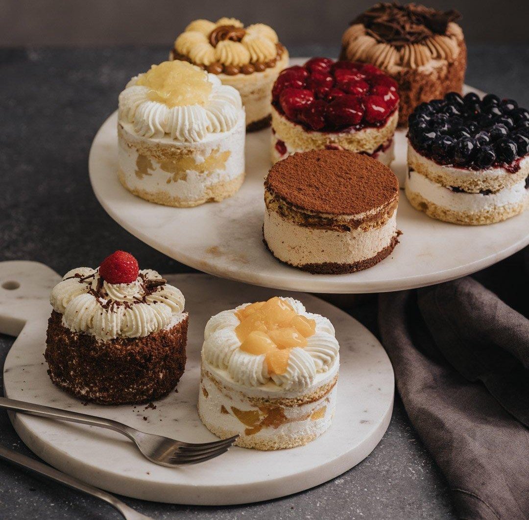Assorted cream patisserie with fruit toppings on marble